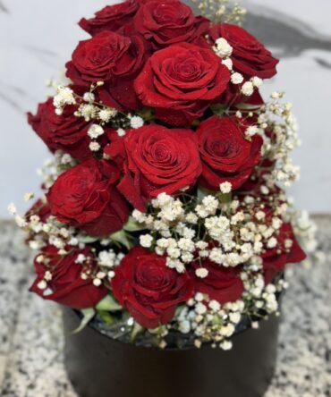 a bouquet of red roses and white flowers