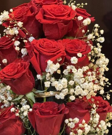 a bouquet of red roses and white flowers